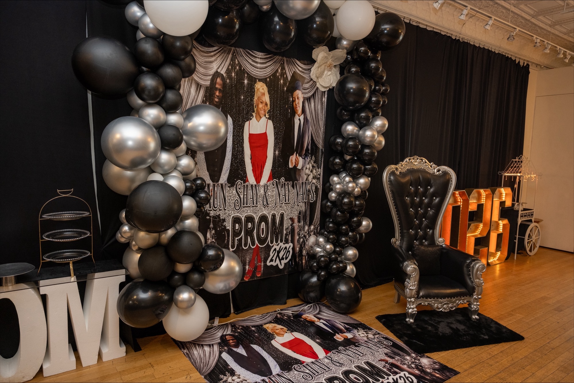 Prom backdrop with balloon decor and throne chair