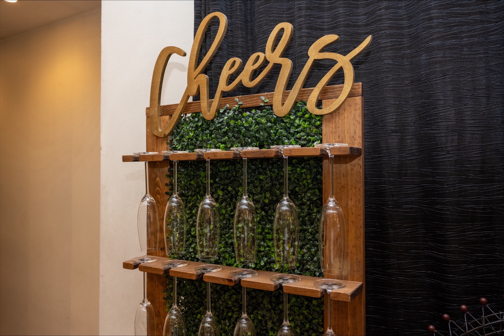 Cheers display wall with hanging glasses at a private event