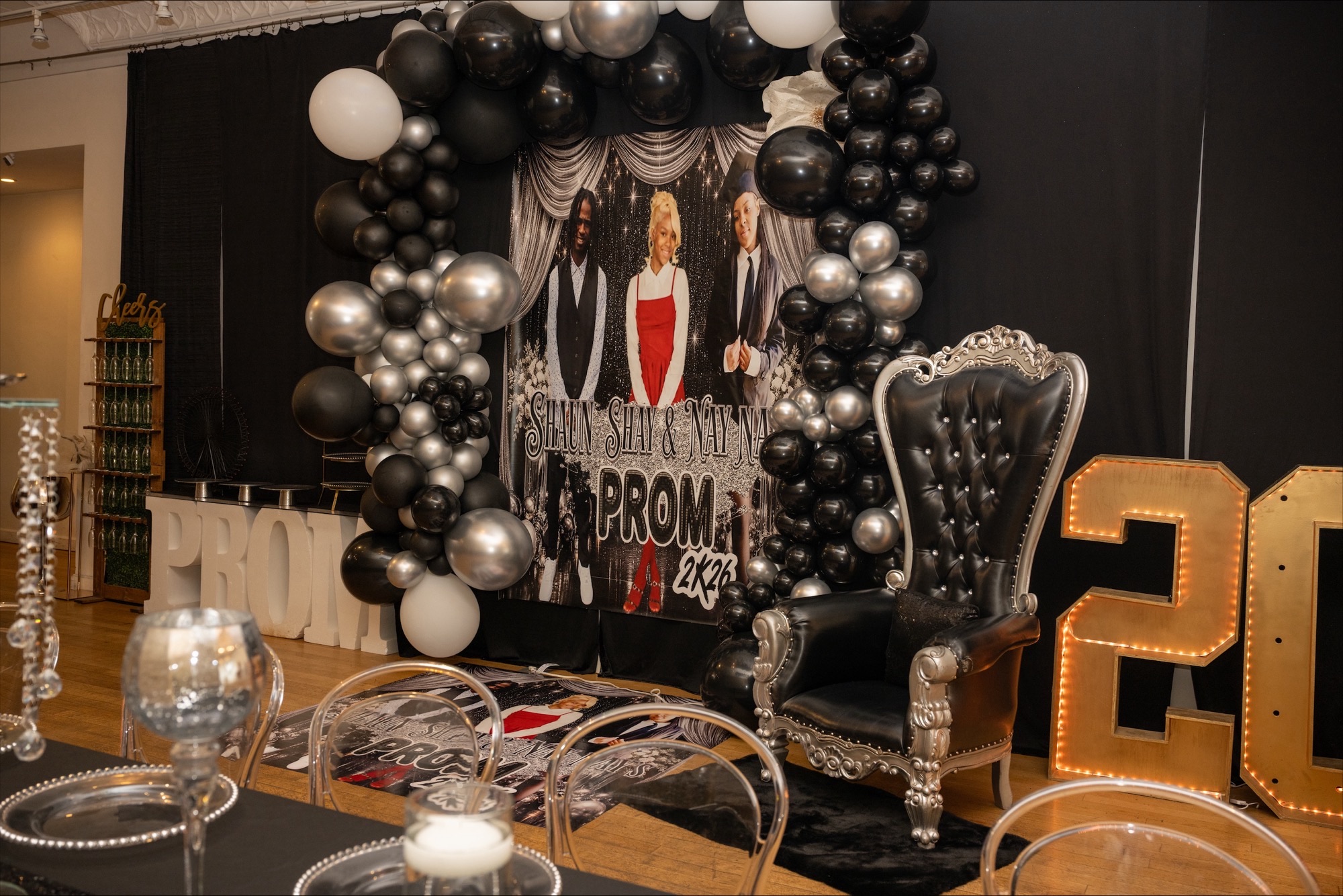 Prom-themed balloon installation and throne chair event setup